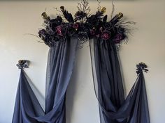 two blue drapes with flowers hanging on the wall