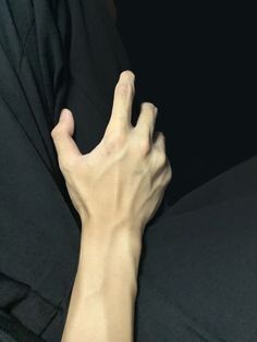 a person's hand reaching for something on the couch