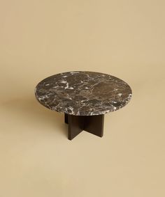 a round marble table with black metal legs