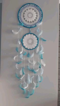 two blue and white dream catchers hanging on the wall