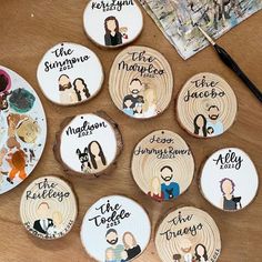 wooden coasters with family pictures on them sitting on a table next to paintbrushes