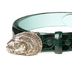 A Cape Cod tradition, our brass oyster shell buckle is paired with a genuine American alligator leather belt strap. The handcast genuine brass buckle is securely held in place by two snaps that can be opened to accommodate various buckles in 1-1/4" size. Made in America. Solid brass oyster buckle Size: 1-1/4" in width Snap closure; buckle is removable Glazed Forest Green alligator belt strap. Made in America Fit guide: we recommend ordering 2" larger than your pant size. Sips in 2 - 3 weeks. Luxury Adjustable Brass Buckle Belt Buckles, Alligator Belt, American Alligator, Oyster Shell, Brass Buckle, Luxury Gifts, Made In America, Cape Cod, Belt Size