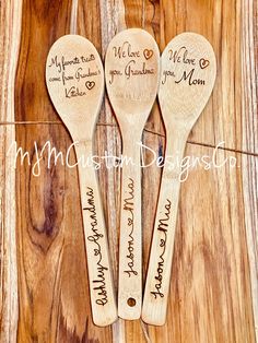 three wooden spoons with names on them