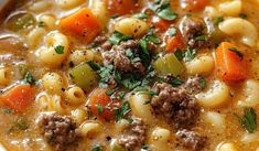 a white bowl filled with pasta and meat soup