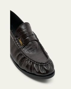 Saint Laurent crinkle calf leather penny loafers with YSL medallion accent    0.50 in / 15 mm flat heel    Round moc toe    Notched vamp with keeper strap    Slipon style    Leather outsole    Made in Italy Penny Loafers, Calf Leather, Penny, Saint Laurent, Tops Designs, In Italy, Loafers, Italy, Luxury Fashion