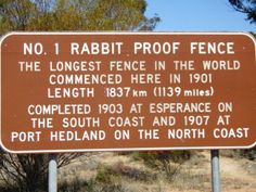 a brown sign sitting on the side of a road