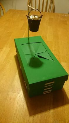 a green box sitting on top of a wooden table