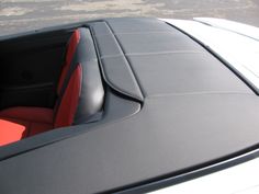 the interior of a car with red and black seats