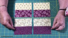 two hands are working on some quilts with purple and white squares in the middle