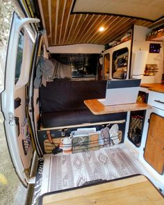 the interior of a camper van with wood flooring