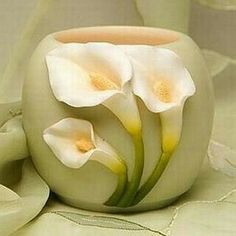 two white flowers sitting inside of a vase