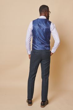 Look stylish in this men's blue tweed waistcoat. This timeless piece is crafted from premium poly wool mix tweed and features a single-breasted design for a flattering fit. Pair with your favourite trousers for a classic and handsome look. Model wears size 38R. Features Slim fit Single-breasted Five button fastening Adjuster straps Complimentary pocket square Style Tip | ﻿Pair with a crisp white shirt, black tie and matching trousers for a stylish occasional look. Composition Main: 80% Polyester Pocket Square Styles, Men's Waistcoat, Tweed Trousers, Tweed Waistcoat, Blue Tweed, Tweed Suits, Crisp White Shirt, Tweed Blazer, Three Piece Suit