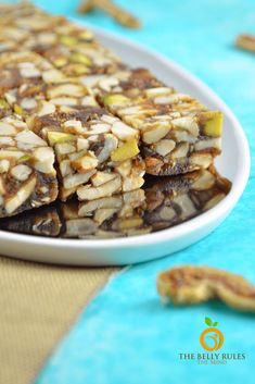 a white plate topped with granola bars on top of a blue and yellow table cloth