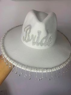 a white hat with the word bride written on it