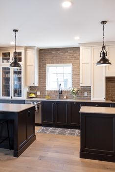 a kitchen with an island and two pendant lights