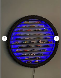 a clock that has cars on it in the shape of a circle with blue lights