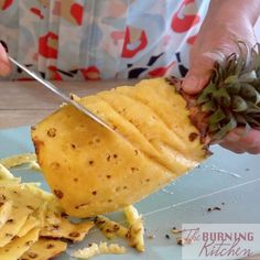 someone is cutting up some pineapple on a plate