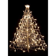 a lighted christmas tree in the dark with white lights on it's top and bottom