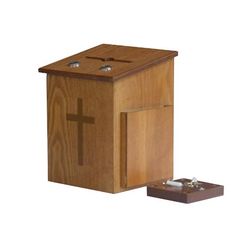 a small wooden box with a cross on the front and one piece of wood below it