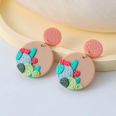 the earrings are decorated with colorful designs on them