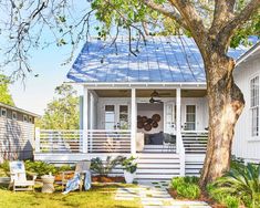 a small white house with a blue roof