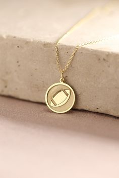 Gold American Football Pendant - American Football Ball Gold Necklace ● Material of pendant: Solid Gold 14k ( REAL GOLD ) ● Metal Stamp: 14k ( REAL GOLD ) ● The pendant is available in 5 sizes: - 12,7 mm / 0.5 inches (Diameter) - 14,0 mm / 0,55 inches ( Diameter ) In the photos - 15,3 mm / 0.6 inches ( Diameter ) - 16,5 mm / 0,65 inches ( Diameter ) - 19,1 mm / 0,75 inches ( Diameter ) ( In the photos the size is 14mm / 0.55 inches Diameter ) ( Jump Ring inner diameter: 4 mm ) ● Material of chai Gold Charm Necklace With Round Pendant For Gift, White Gold Plated Charm Necklace With Round Pendant, White Gold Plated Round Pendant Charm Necklace, 14k Stamped Pendant Necklaces For Anniversary, 14k Stamped Pendant Necklace For Anniversary, 14k Gold Stamped Pendant Necklaces For Anniversary, Personalized Yellow Gold Pendant Charm Necklace, Personalized Yellow Gold Charm Pendant Necklace, White Gold Round Charm Necklace As Gift