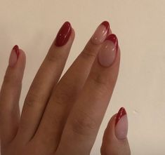 a woman's hand with red nail polish on it and an oval shaped manicure