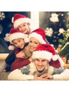 a family wearing christmas hats posing for a photo