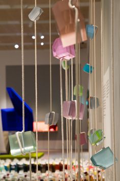 colorful glass pieces hanging from strings in a room