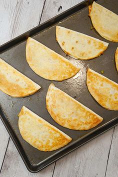 some tortillas are sitting on a baking sheet and ready to be cooked in the oven