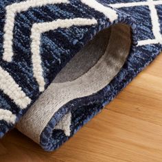 a blue and white rug with a wooden floor