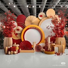 an assortment of decorative plates and vases on display in a room with red decorations