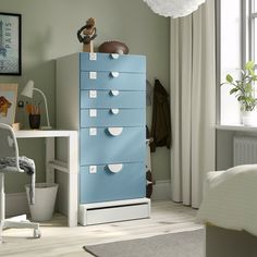 a blue and white filing cabinet in a bedroom