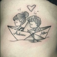 a couple in a paper boat tattoo on the back of a woman's stomach