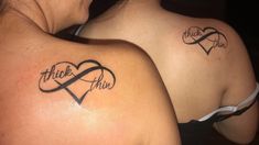 two women with matching tattoos on their backs, one has a heart and the other has an i love you tattoo