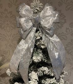 a christmas tree with silver and white decorations