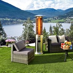 a fire place sitting on top of a lush green field