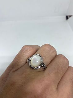 Lovely polished 925 sterling silver with a huge white Mother Of Pearl set in very detailed vintage filigree Size 7 or 9 We can size these with an additional $10- $20 fee for the jeweler All rings are shipped in a nice gift box. Check out our over a THOUSAND great reviews Engraving is $4 per letter and is not always perfect depending on the piece. It can take a few days if the jeweler is busy. This is payable to Paypal Judithsltd@gmail.com Heirloom Silver Oval Pearl Ring, Classic White Oval Moonstone Ring, White Fine Jewelry With Filigree Details, Classic White Moonstone Ring In Sterling Silver, White Filigree Fine Jewelry, Vintage White Oval Cabochon Ring, White Fine Jewelry With Filigree, Classic White Cabochon Moonstone Ring, Fine White Filigree Jewelry