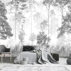 a bedroom with a bed, chair and wallpaper that has trees in the background