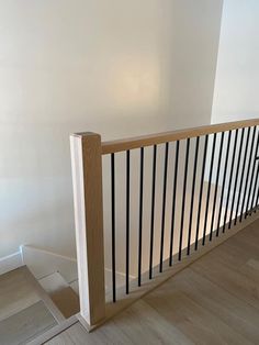 an empty room with white walls and wooden railing