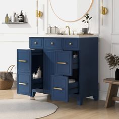 a bathroom with a sink, mirror and blue cabinet