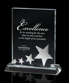 an award plaque with stars on it and the words excellence written in cursive writing