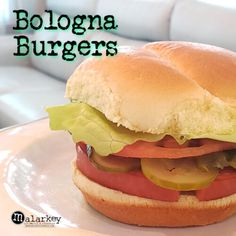 a close up of a sandwich on a plate with the words bologna burgers above it