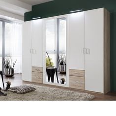 a large white and wood wardrobe with mirrors