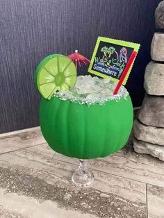 a green drink in a glass filled with ice