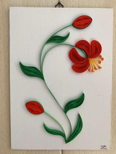 a piece of paper with red flowers on it