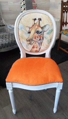 an orange chair with a giraffe painted on it's back and seat