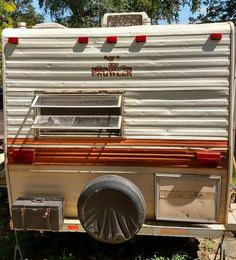 an old camper is parked in the grass