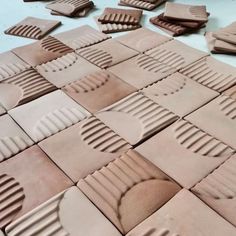 several pieces of clay sitting on top of a table next to each other with hearts carved into them