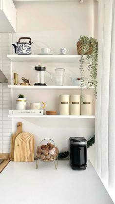 a kitchen with white walls and shelves filled with food